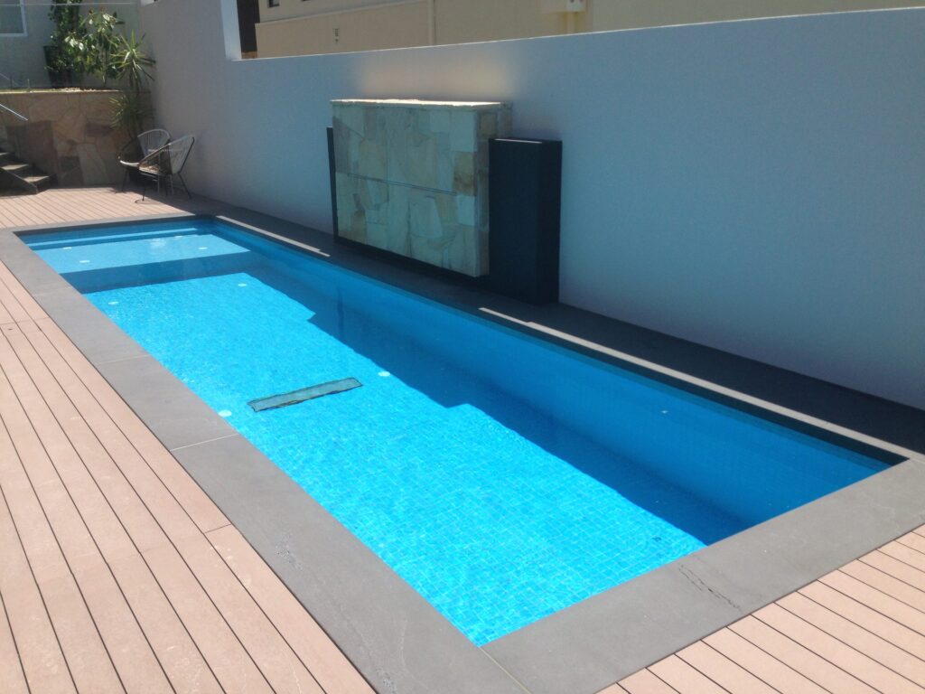 Composite deck lap pool in Wheelers Hill by InEx Lifestyle Design landscapers