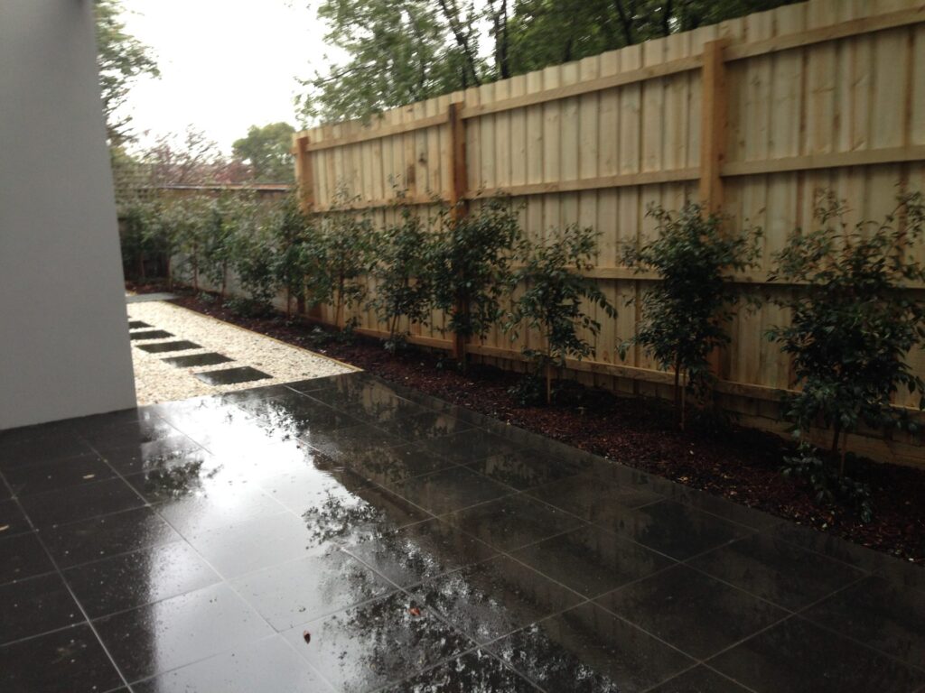 Tiled courtyard in Glen Iris by InEx Lifestyle Design landscapers