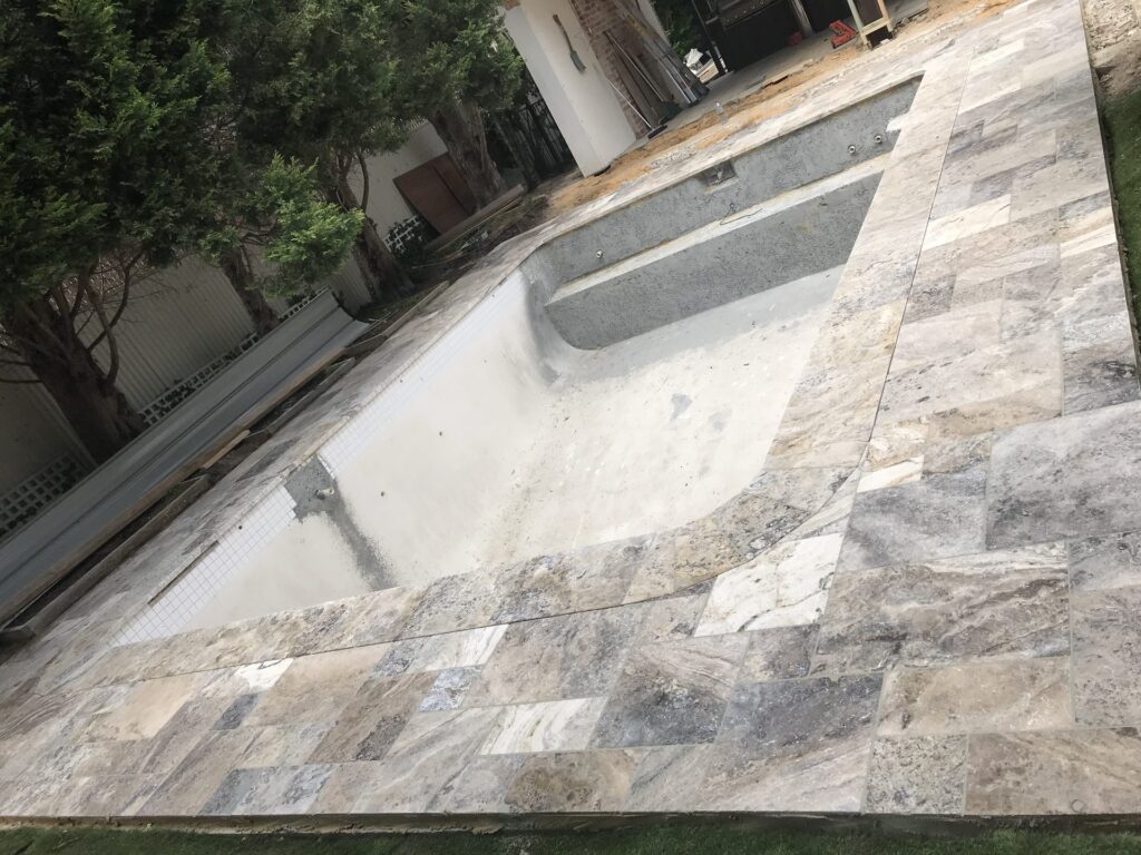 Travertine pool coping in Brighton by InEx Lifestyle Design landscapers